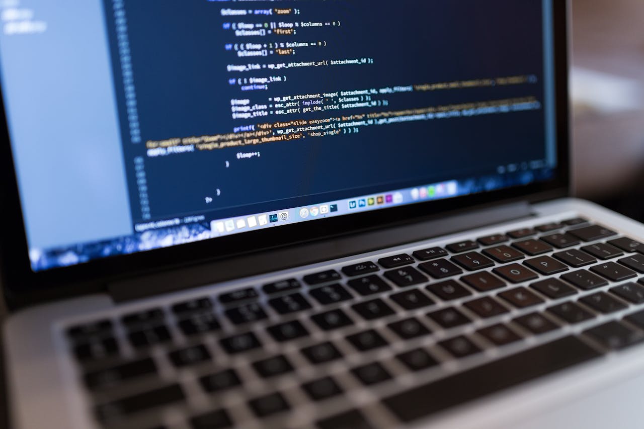 Services Focused view of programming code displayed on a laptop, ideal for tech and coding themes.