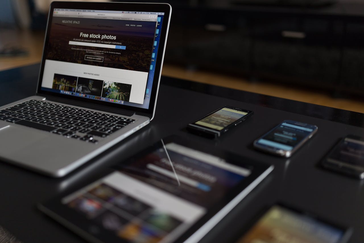 Services A contemporary workspace showcasing a laptop, tablet, and smartphones, ideal for tech and freelance use.